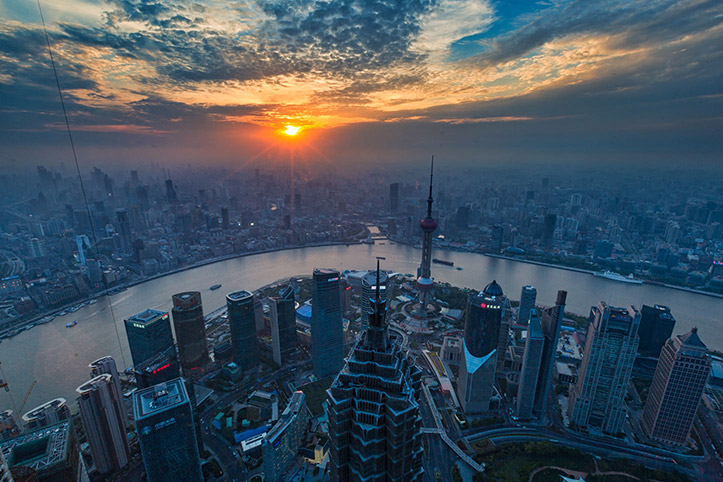 Sun disappears behind the clouds on Shanghai's Pudong and Puxi skyline from the SWFC Observation Deck