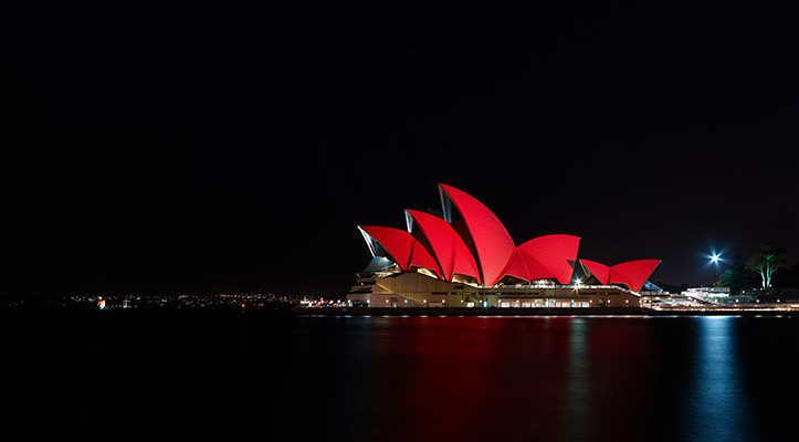 sydney opera house night red chinese new year spring festival harbour water lights encore