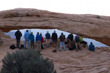 photographers blocking view mesa arch sunrise utah canyon national park usa unfair