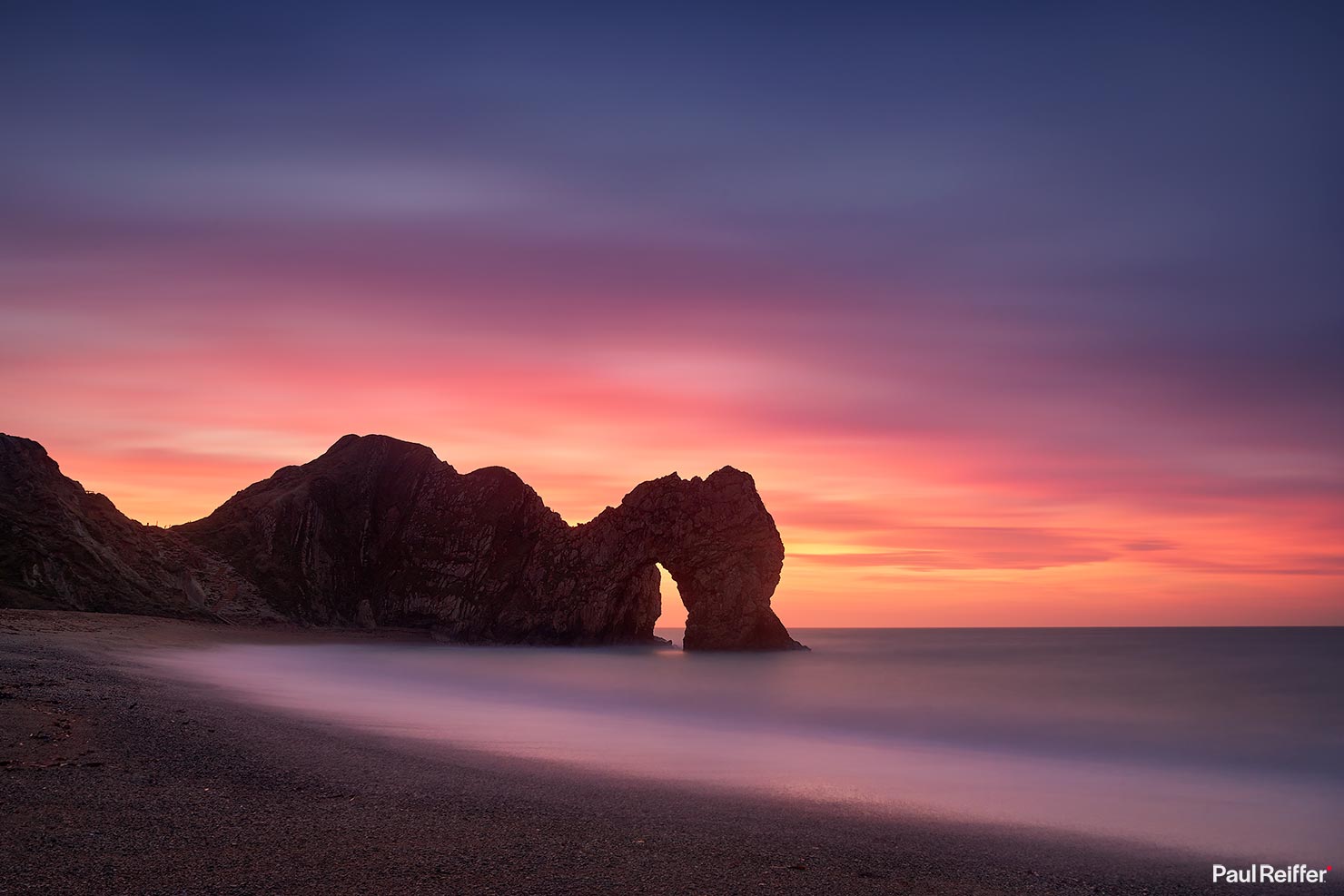 Durdle Door Sunrise Calm Pink Sky Beach Winter Jurassic Coast Dorset UK England World Heritage Paul Reiffer