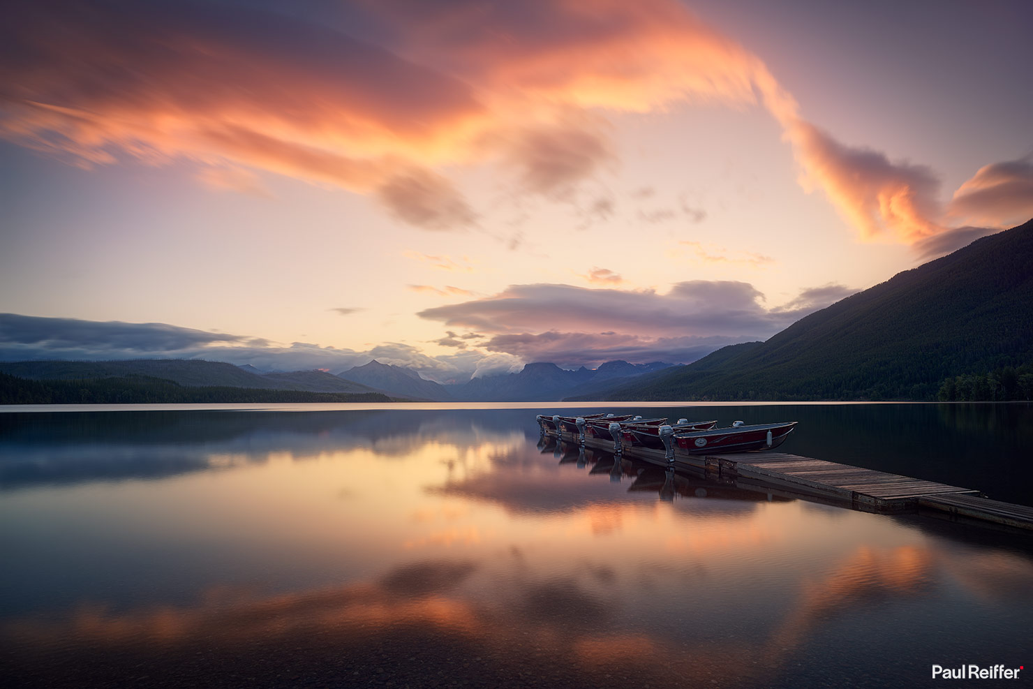 Lake McDonald Sky Dance Sunrise Apgar Montana Glacier National Park Vibrant Skies Reflection Boats Jetty Calm Spring Mountains Paul Reiffer P0012330