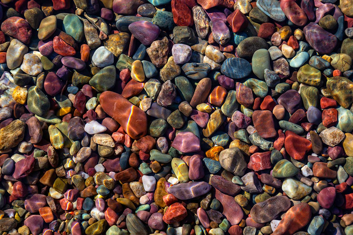 Rainbow Rocks Lake McDonald Fake Images Pebbles Photoshopped Saturation iStock Licensed Editorial Glacier National Park Bull BS Lies False